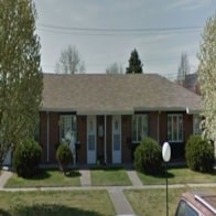 A house with a white door and a brown roof.