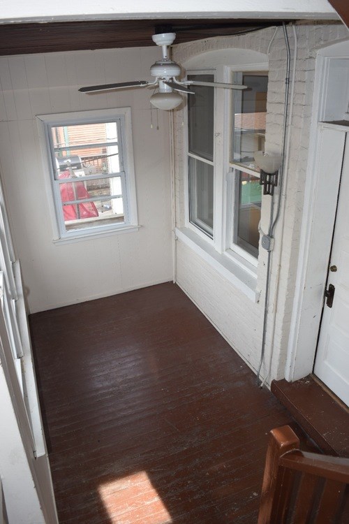 A room with a ceiling fan and a window.