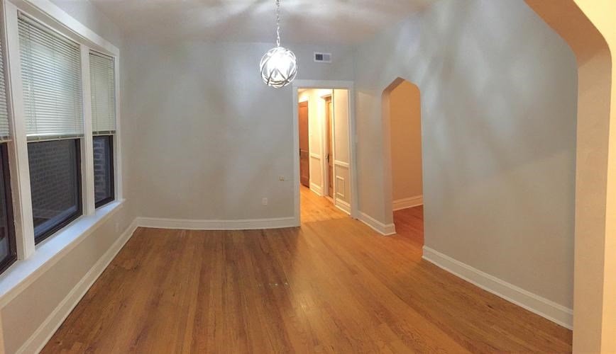 A room with wooden floors and white walls.