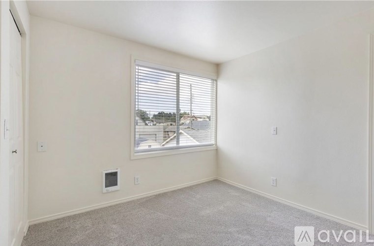 A room with a window and a wall-mounted TV.