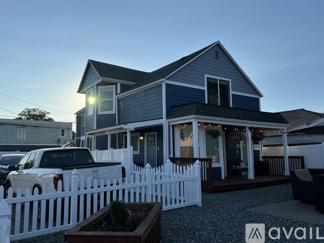 A house with a white picket fence in front of it.