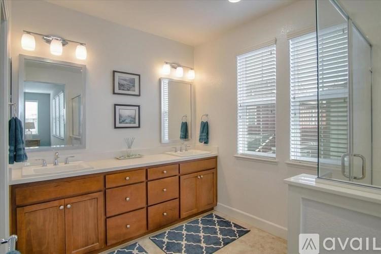 A bathroom with two sinks and a large mirror.