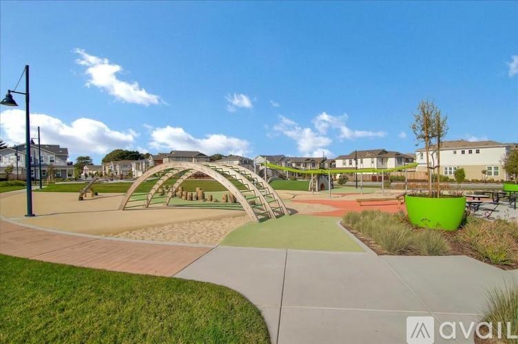 A playground with a green slide and a play structure.