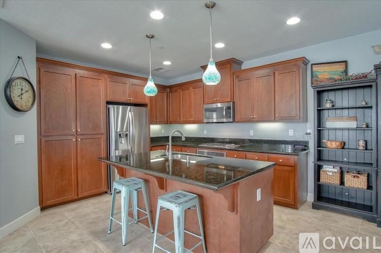 A kitchen with wooden cabinets and a granite countertop.