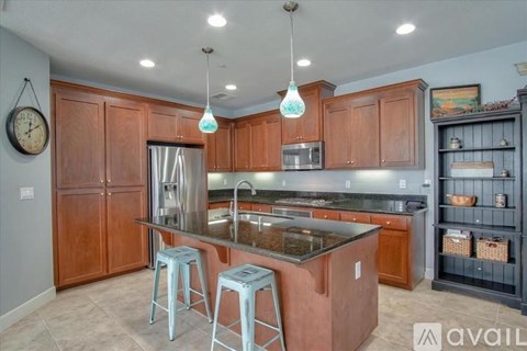 A kitchen with wooden cabinets and a granite countertop.