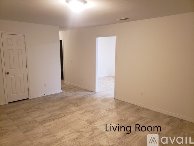 A living room with a door and a window.