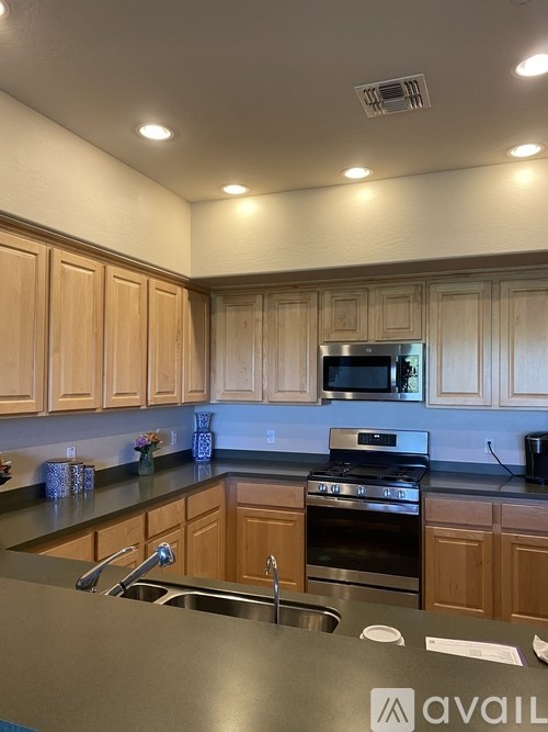 A kitchen with wooden cabinets and a stainless steel sink.