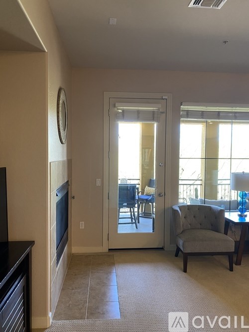 A living room with a grey armchair and a television.