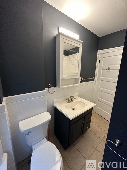 A bathroom with a white toilet and a white sink.