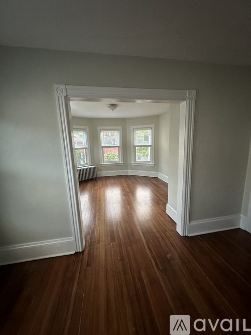 A room with wooden floors and white walls.