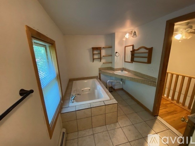A bathroom with a tub and a sink.