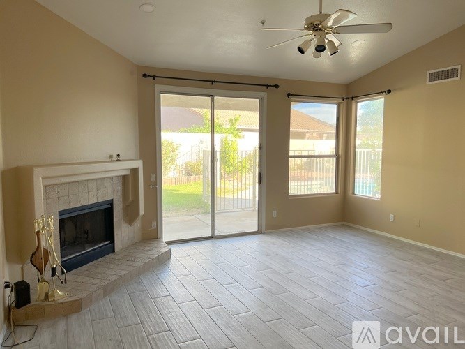 A living room with a fireplace and sliding glass doors.
