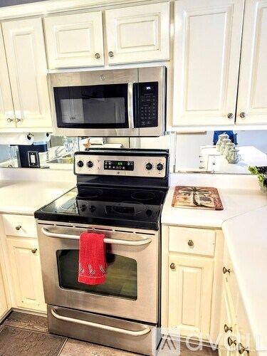 A kitchen with a stove top oven and microwave above it.
