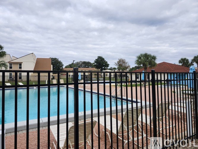 A pool surrounded by a black fence with the word "OXO" on it.