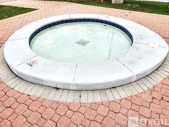 A round pool with a red brick border.