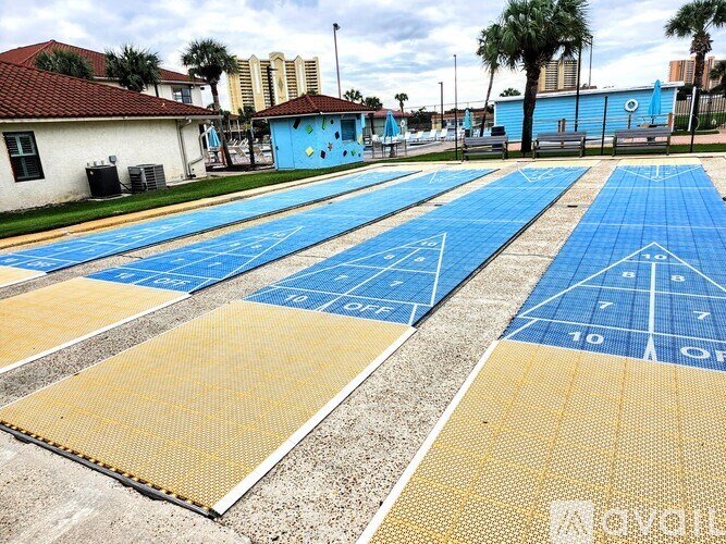 A basketball court with blue and yellow markings is shown.