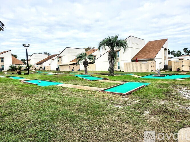 A yoga mat is laid out on the grass in front of a building.