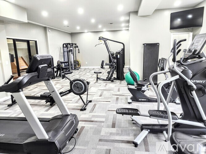 A well-equipped gym with treadmills, elliptical machines, and other exercise equipment.