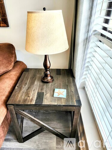 A table with a lamp on it and a star sticker on the table.