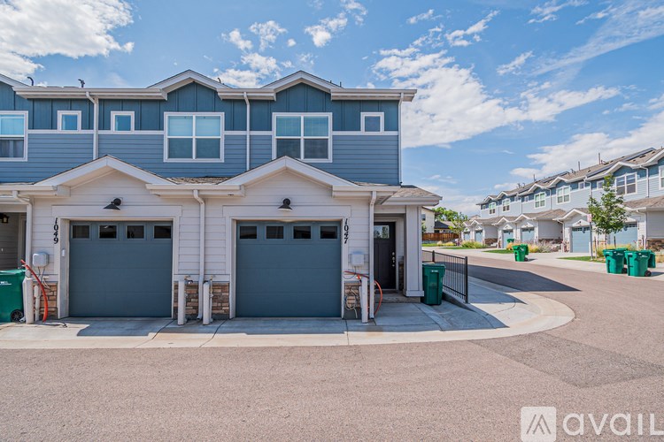 A row of houses with a clear blue sky above them.