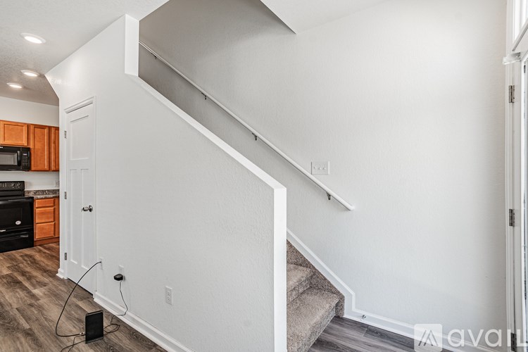 A staircase in a house with a black speaker on the floor.