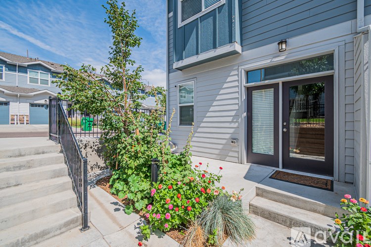A house with a front yard and stairs leading to the entrance.