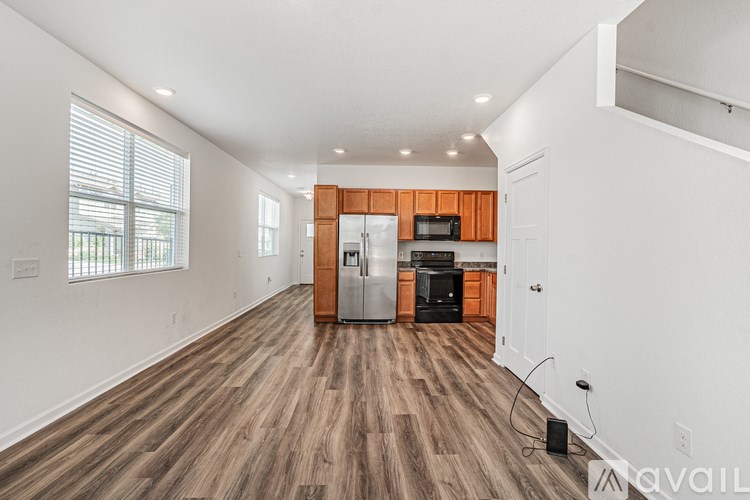 A kitchen with wooden floors and white walls.