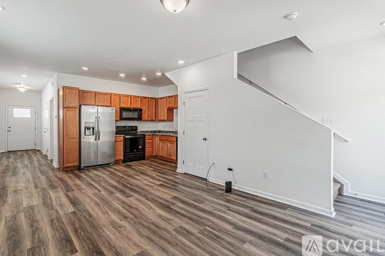 A kitchen with wooden cabinets and a refrigerator.