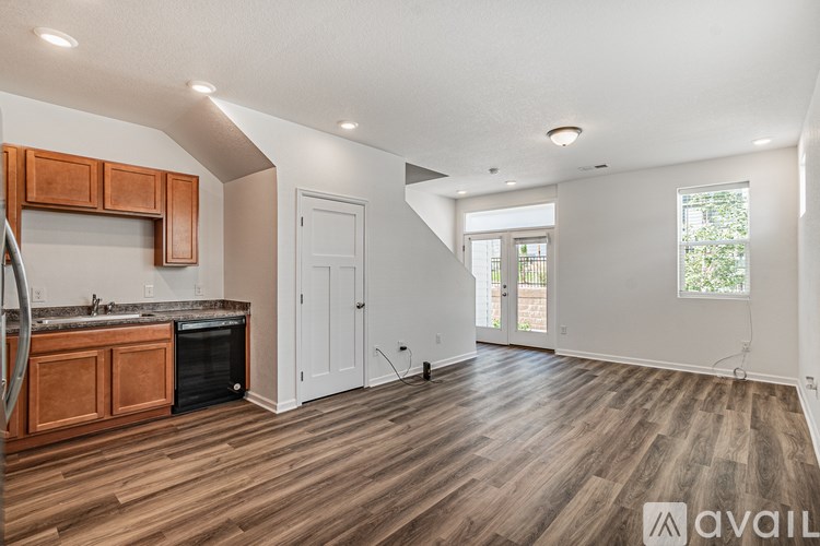 A kitchen with wooden floors and a white ceiling.