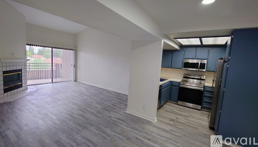 A spacious living area with a kitchenette and a fireplace.