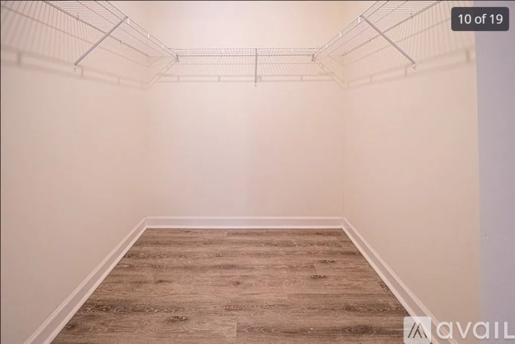 Empty room with wooden floor and white walls.