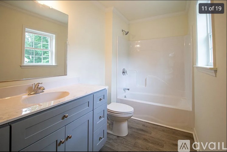 A bathroom with a white toilet and a sink.