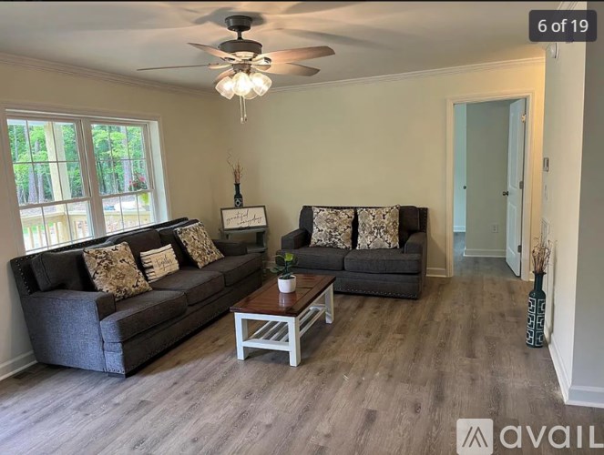 A living room with two grey couches and a coffee table.