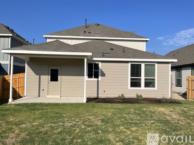 A house with a grey roof and a brown fence.