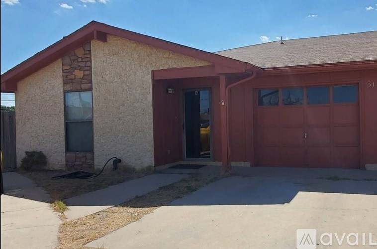 A house with a red garage door is for sale.