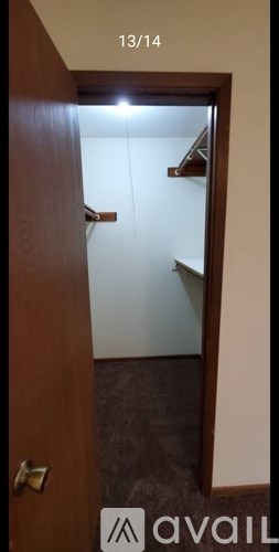 A wooden door with a glass window and a handle.