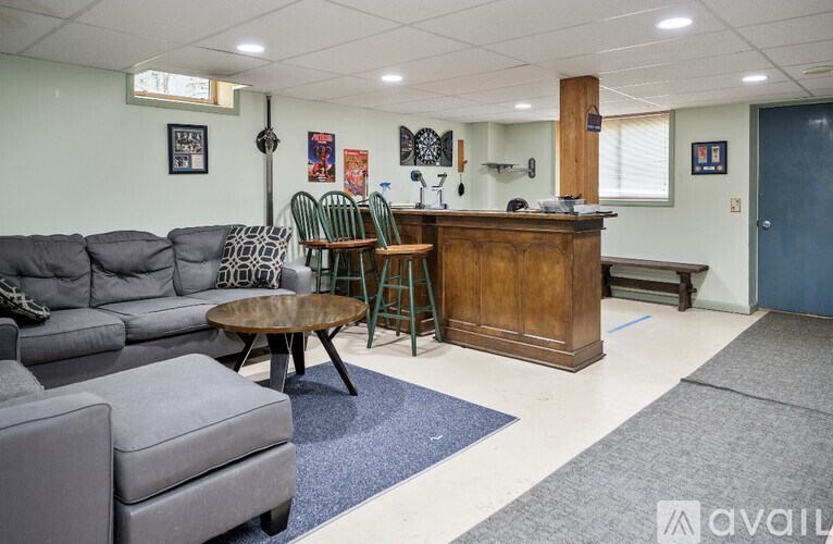 A living room with a grey sofa and a wooden cabinet.