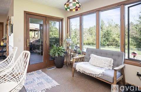 A living room with a grey couch and a white chair.