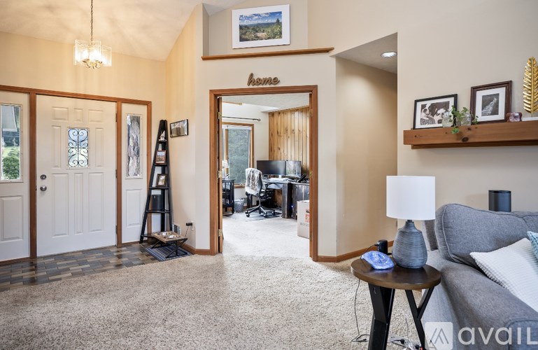 A living room with a grey couch and a wooden coffee table.