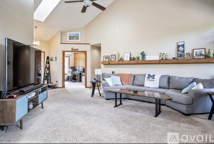A living room with a grey couch and a television.
