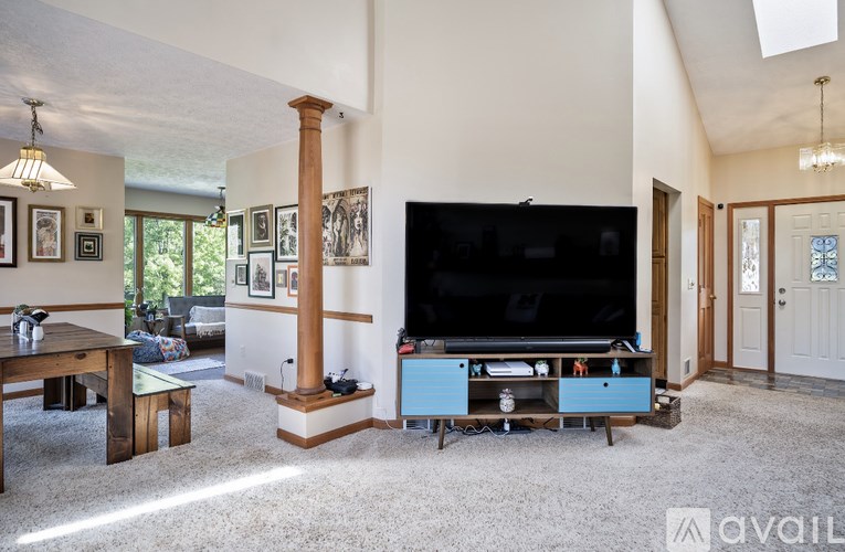 A living room with a television and a table.