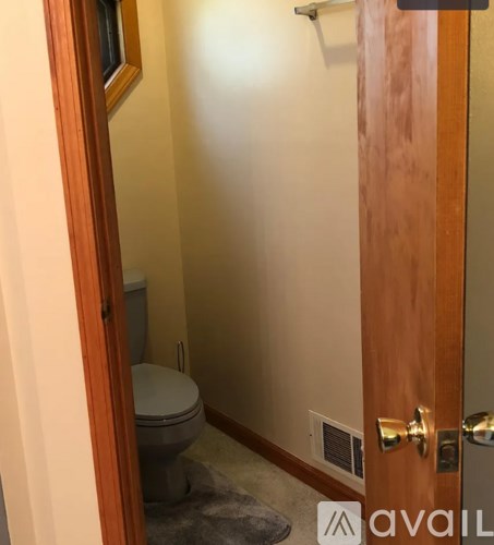 A bathroom with a toilet and a door.