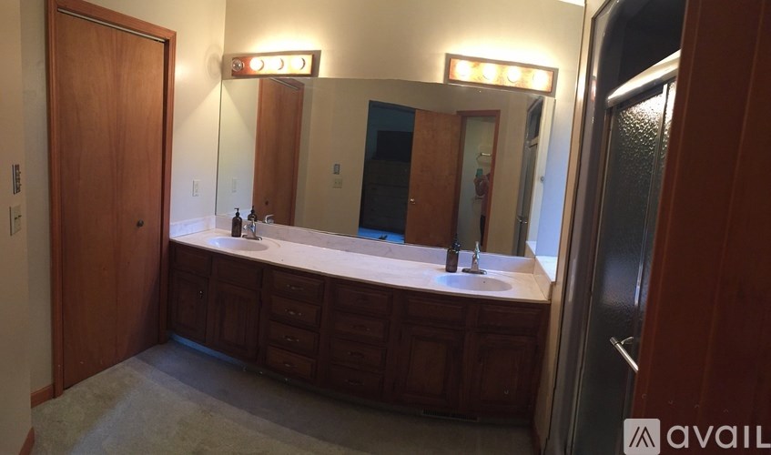A bathroom with a vanity and a mirror.