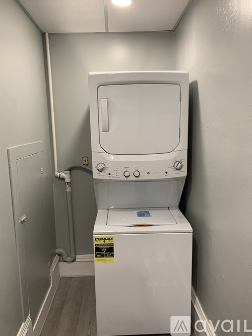 A white washing machine in a small laundry room.