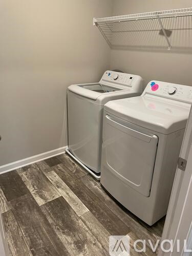 Two front loading washing machines in a laundry room.