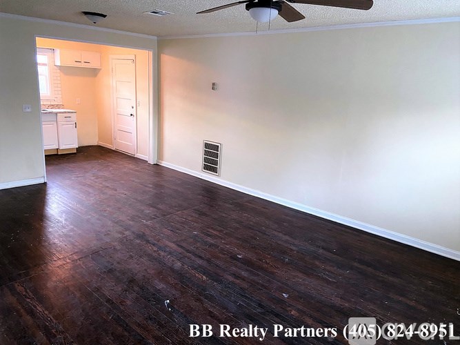 A room with a ceiling fan and hardwood floors is on the market with BB Realty Partners.