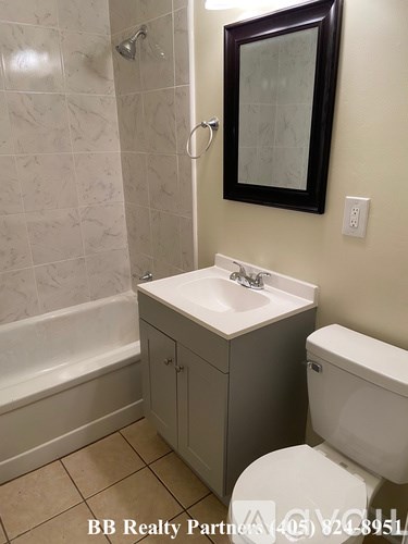 A white toilet sits next to a sink in a bathroom.