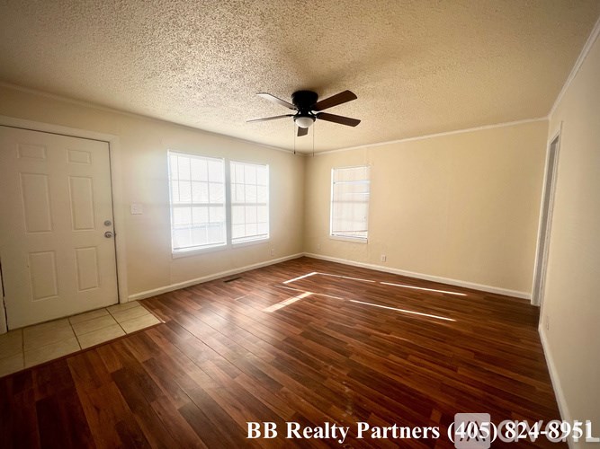 A room with a BB Realty Partners sign on the floor.