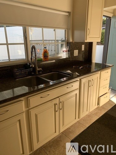A kitchen with a sink and cabinets.