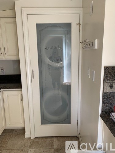 A white fridge with a glass door in a kitchen.